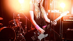 female electric guitarist playing with band