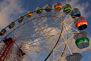 low angle photo of white, green, and blue ferris wheel under white and blue cloudy sky during daytime HD wallpaper