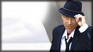 man wearing black hat and suit vest