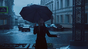 photo of woman in black coat and umbrella