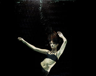 woman wearing black bikini set underwater