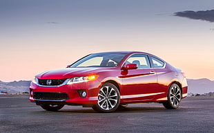 red Honda Civic coupe parked on concrete pavement