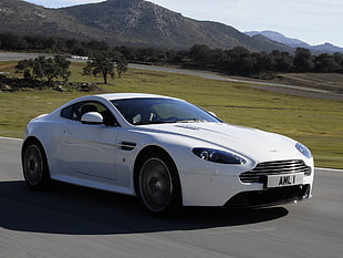 white Aston Martin coupe running on road during daytime