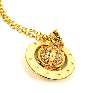 close-up photo gold-colored round chest box pendant