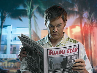 man holding The Miami Star newspaper