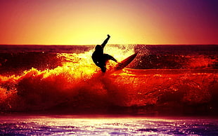silhouette of person surfing
