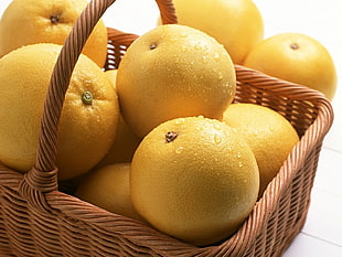 lemon fruit in brown wicker basket