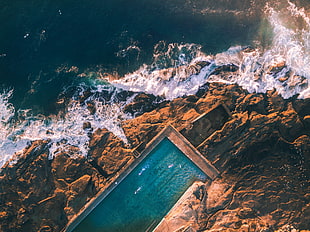 aerial view photography of swimming pool near sea at daytime