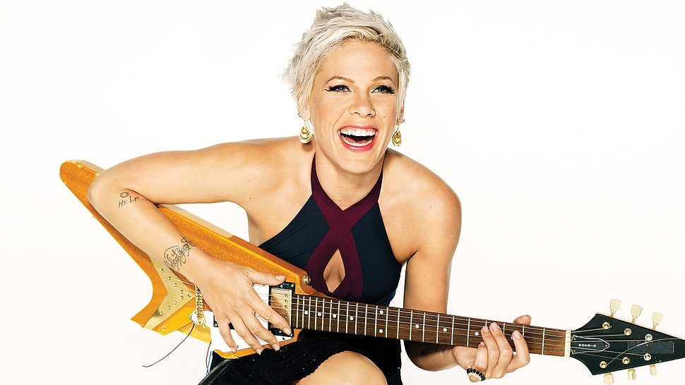 Pink holding brown flying V electric guitar HD wallpaper