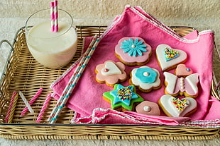 floral cookies beside candle and glass cups