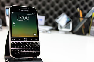 black BlackBerry QWERTY phone with stand