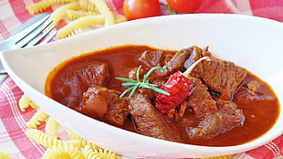 meat stew with chili on white ceramic bowl