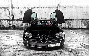 black Mercedes-Benz sports car parked on concrete ground