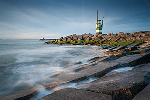 photo of lighthouse near ocean HD wallpaper