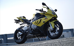 yellow and black BMW sports bike parked on asphalt road