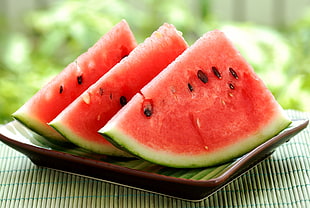 three sliced watermelon on brown plate