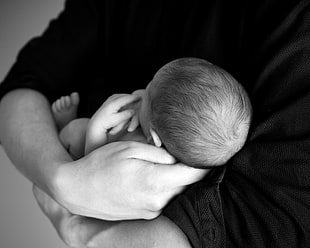 human wearing black top holding baby HD wallpaper