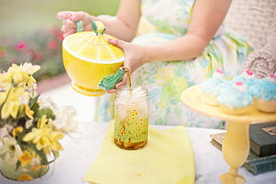 person holding yellow ceramic bowl with lid HD wallpaper