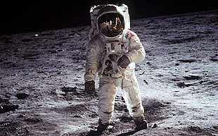 astronaut on brown sand HD wallpaper