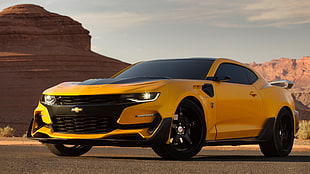 yellow Chevrolet coupe on grey pavement HD wallpaper