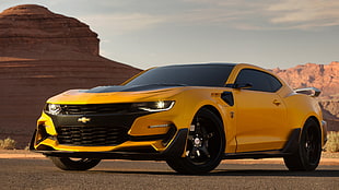yellow Chevrolet coupe on grey pavement