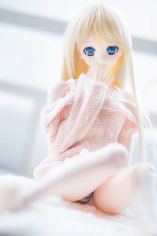 selective photography of blonde-haired anime character on white textile