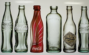 six Coca-Cola glass bottles