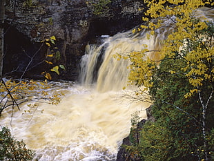 photography of waterfall between green fields HD wallpaper