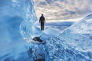 man walking on the ice field during daytime