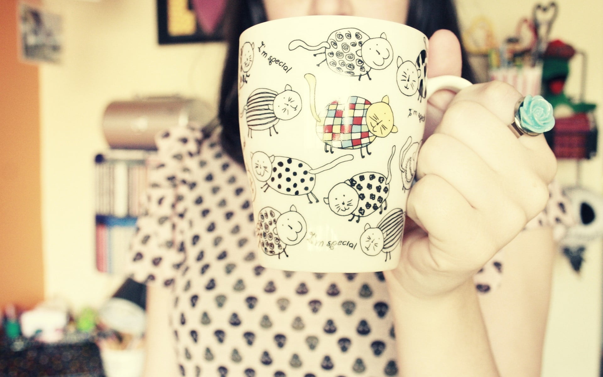 photo of woman holding white ceramic mug