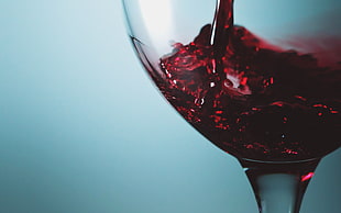 photo of red wine on footed glass