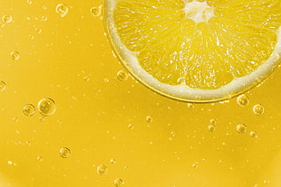 sliced Lemon with juice in macro shot photography