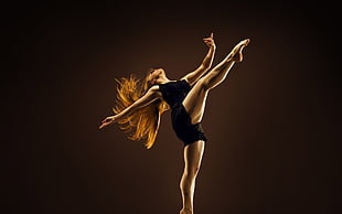 dancing woman in black sleeveless romper