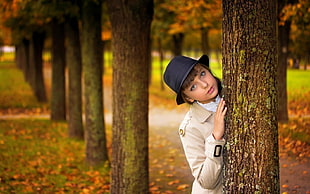 woman in black hat near the tree