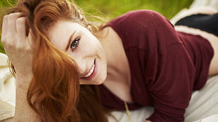 tilt shift lens photography of woman wearing maroon v-neck top
