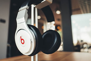 selective focus photography of white Beats by Dr. Dre headphones HD wallpaper