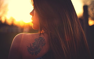 shallow focus photography of woman with fish back tattoo during sunset HD wallpaper