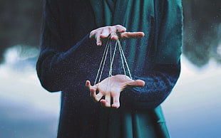man playing with elastic band, hands