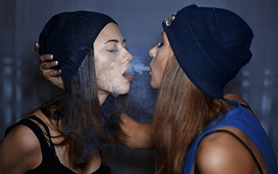 two two black knit caps, women, smoke, smoking, closed eyes