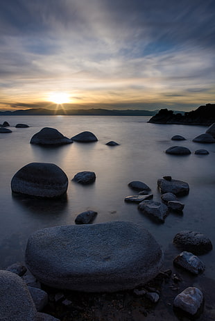 view of rocks on body of water during sunset, lake tahoe HD wallpaper