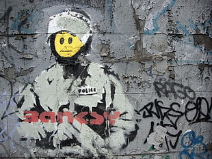 man wearing white and black coat painting, graffiti