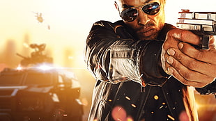 man in black jacket holding pistol