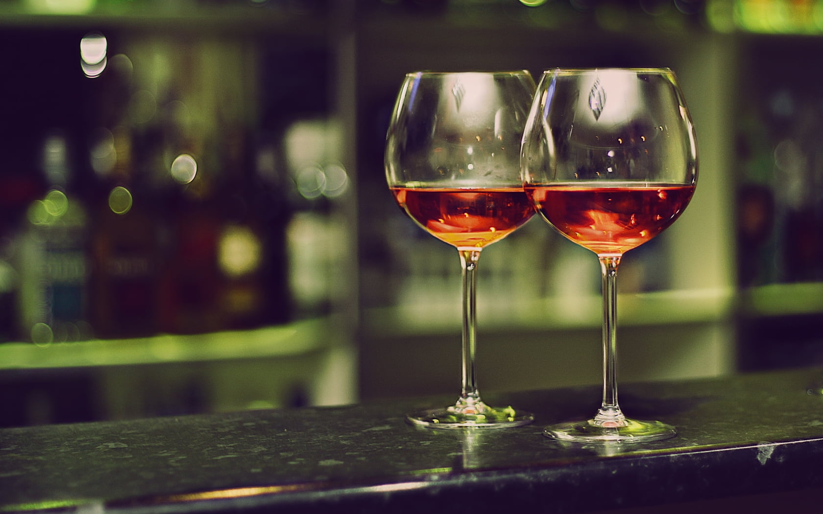 clear wine glasses on black marble counter