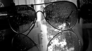 grayscale photo of Aviator sunglasses with water drops