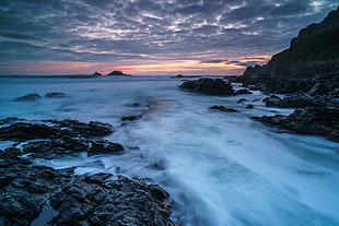 body of water near rock formation, cape cornwall