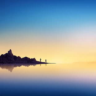 silhouette of two people on rock formation during daytime HD wallpaper