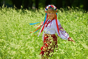 girl wearing red and white long-sleeved dress in flower field