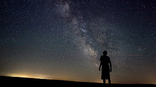 silhouette of person under starry sky