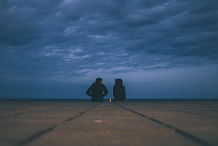 photography of couple sitting on ground