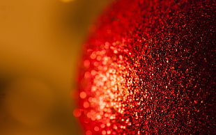 micro photography of red glittered bauble